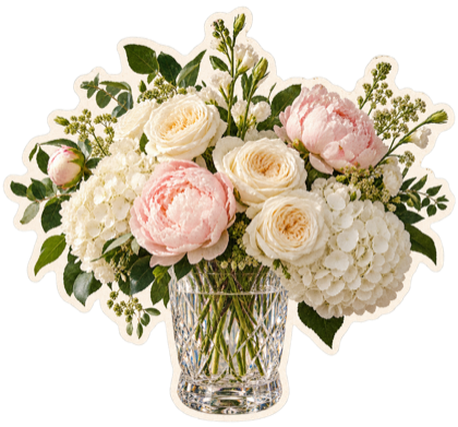 White and blush flowers arranged in a faceted crystal vase.