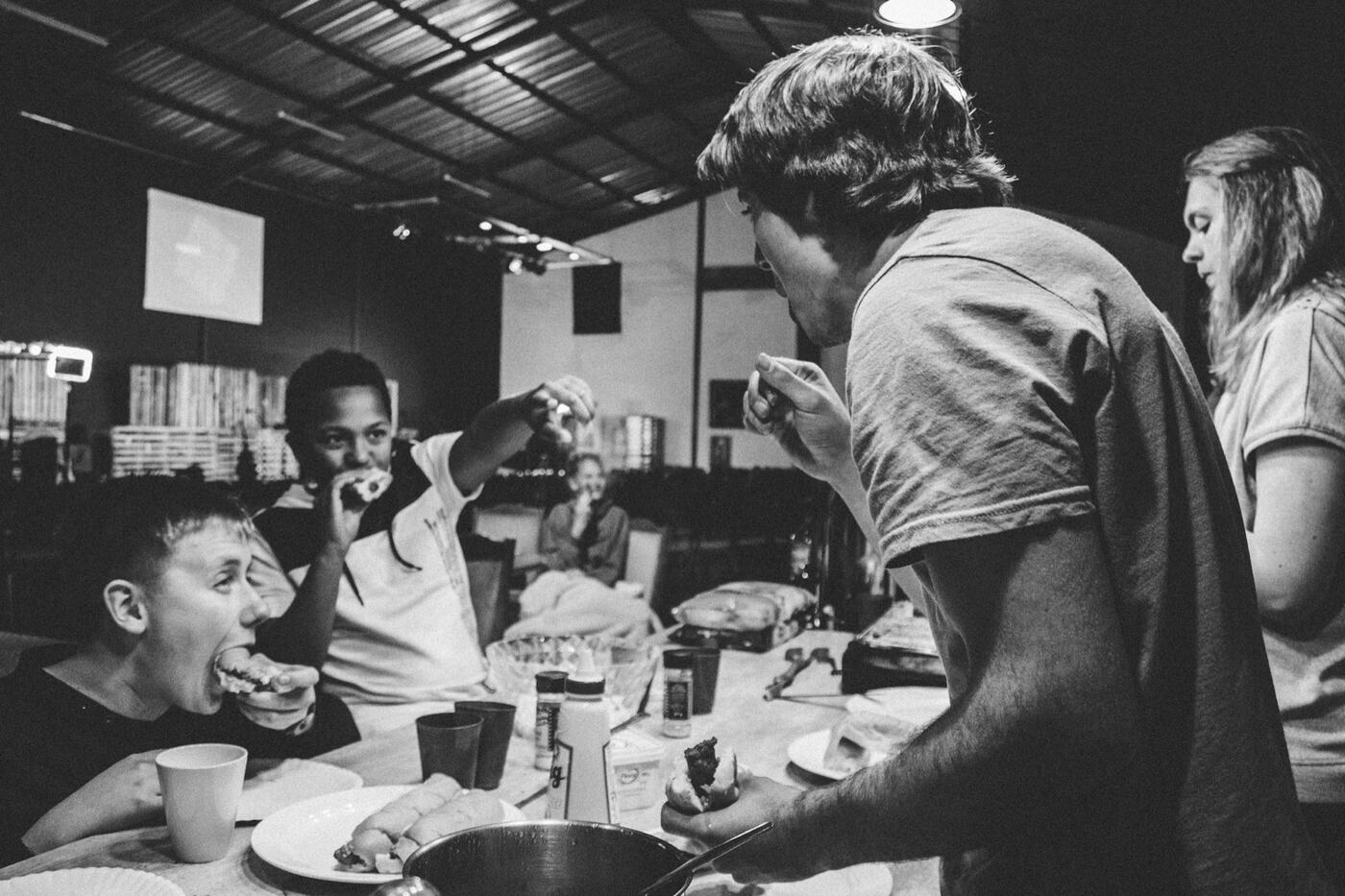 People gathered around a table in black and white.